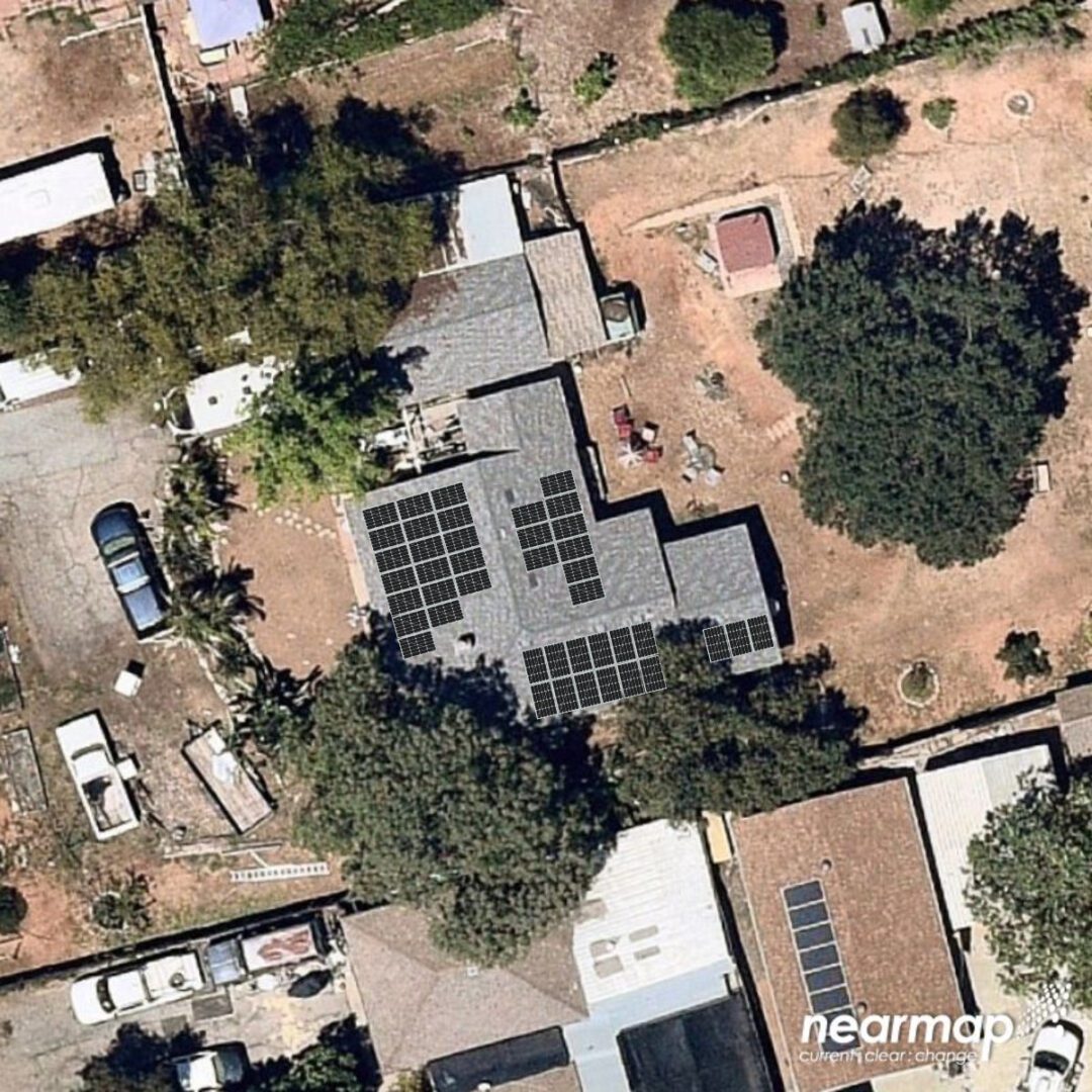 A satellite image of an old house with solar panels on the roof.